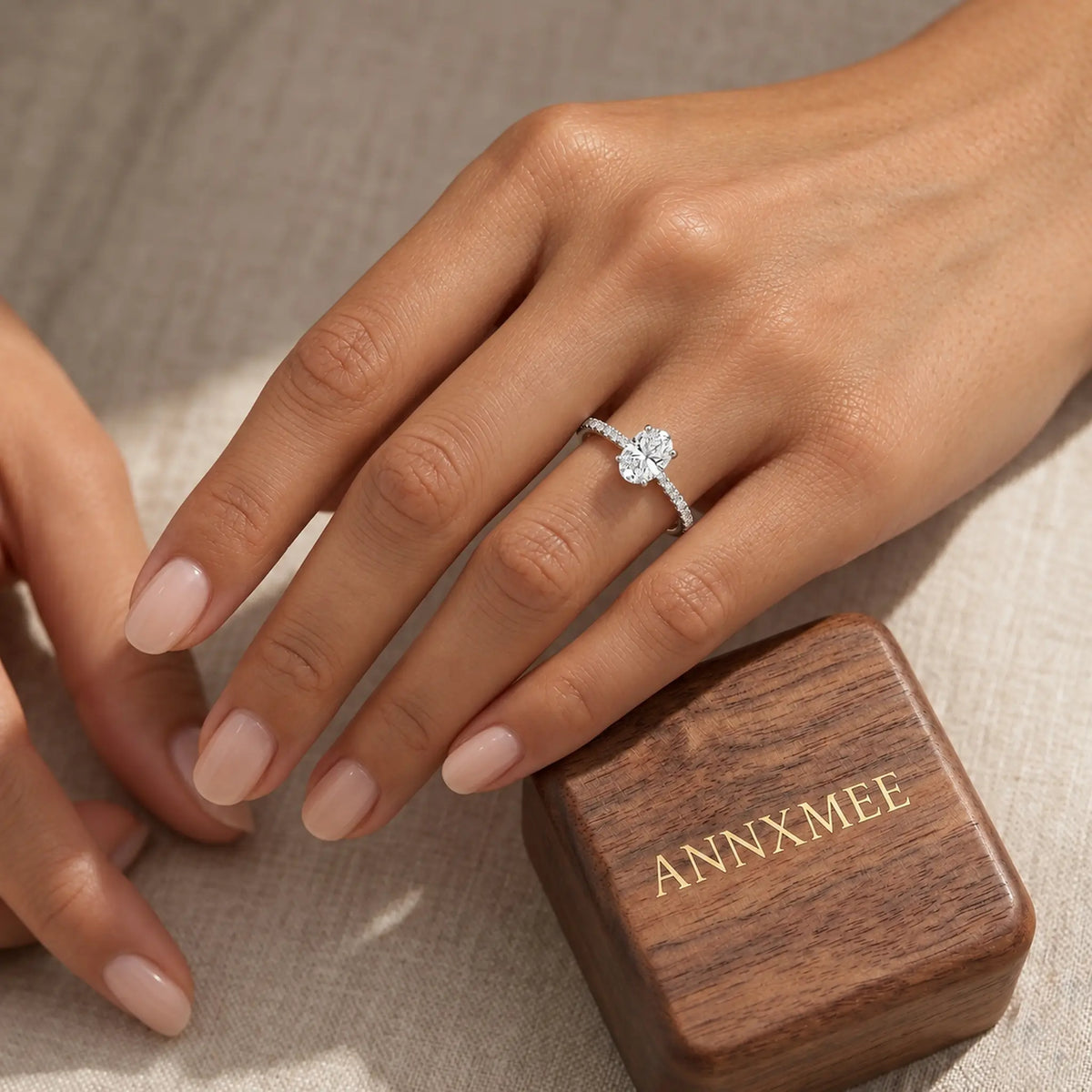 Aurelia oval moissanite engagement ring beside ANNXMEE wooden gift box
