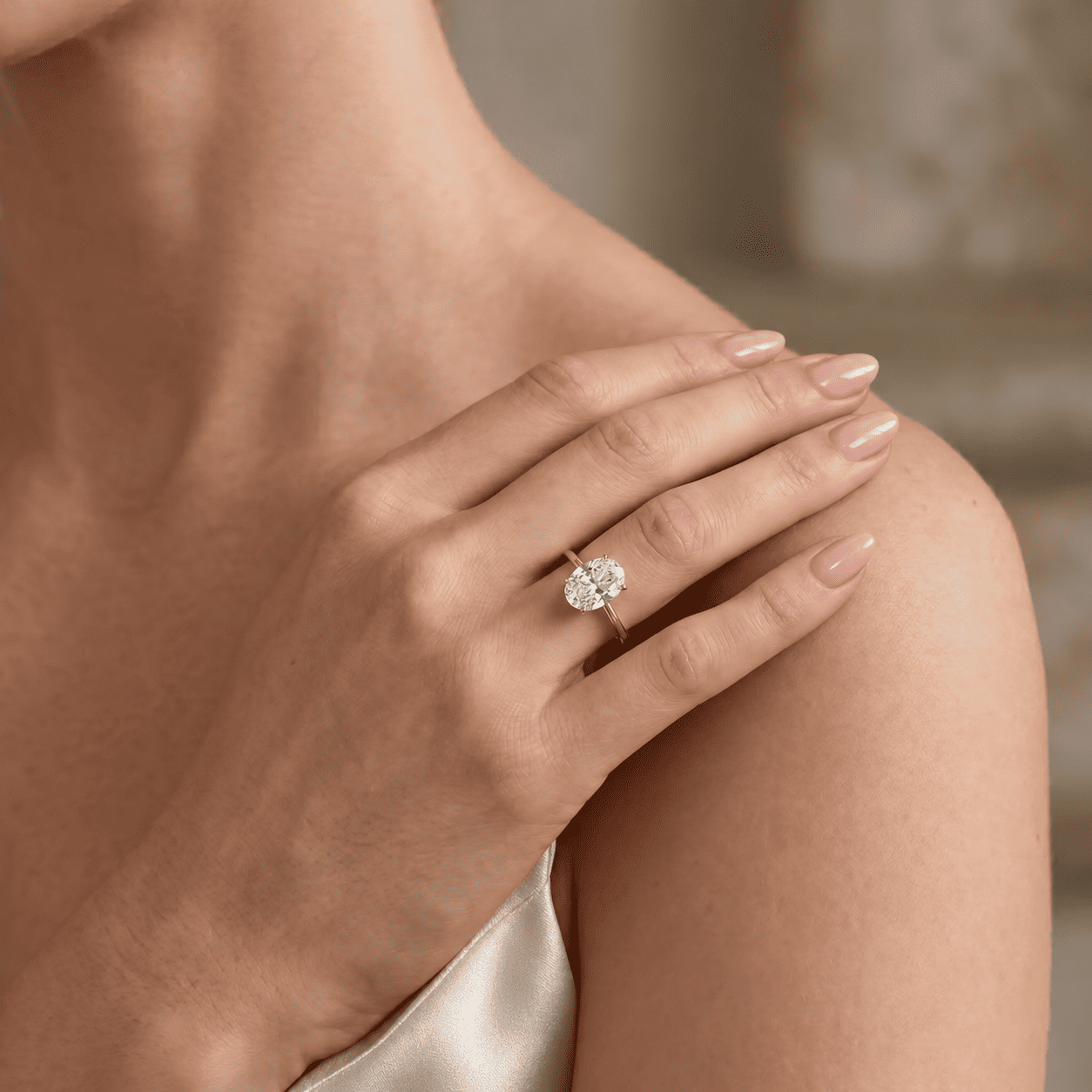 Oval cut moissanite tulip hidden halo ring worn on hand