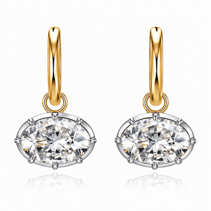 Pair of ANNXMEE Iconic two-tone hoop earrings with horizontal oval moissanite drops on a white background