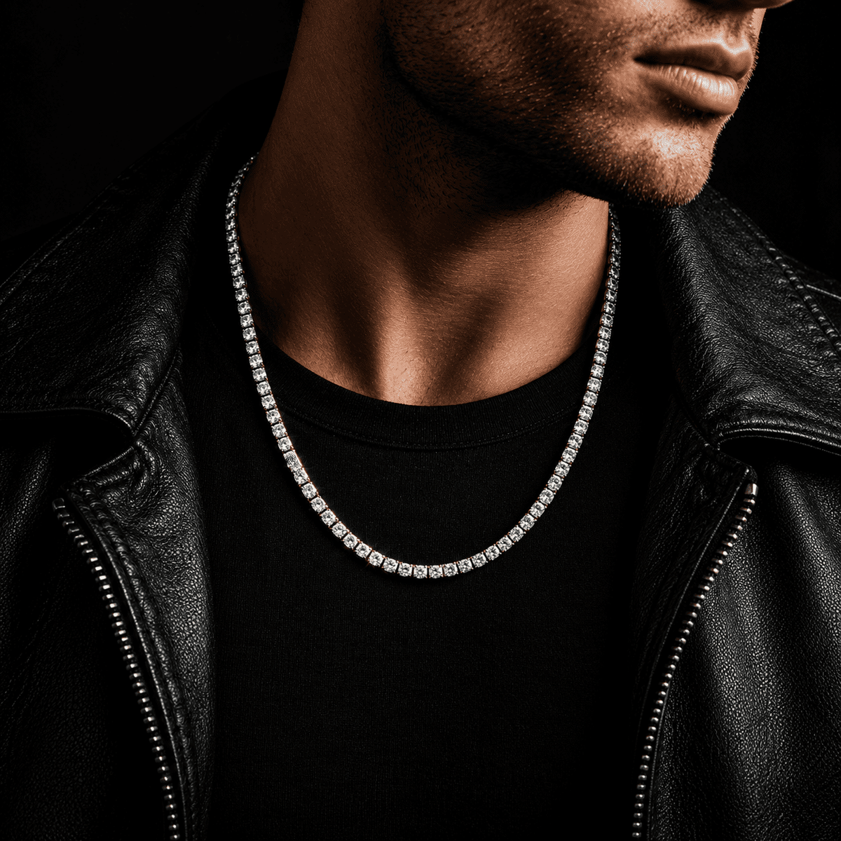 Man wearing a sparkling white gold moissanite tennis chain with a black leather jacket against a dark luxury background